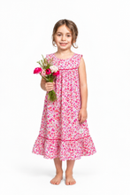 Load image into Gallery viewer, A young girl wearing a sleeveless pink and red floral nostalgic nightgown made from Liberty tana lawn with a ruffled hem.