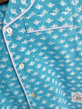Load image into Gallery viewer, Pyjama set detail of white fish on blue background with white piping
